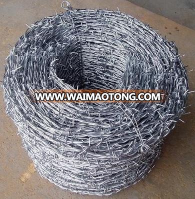 Galvanized barbed wire fence